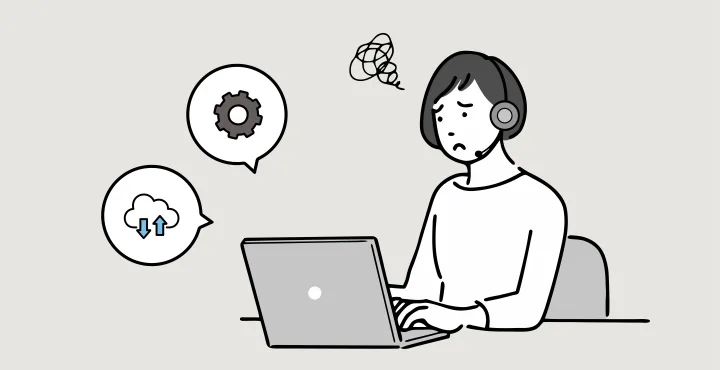 受話器を持って画面を指す情シスと、困った表情の社員のイラスト