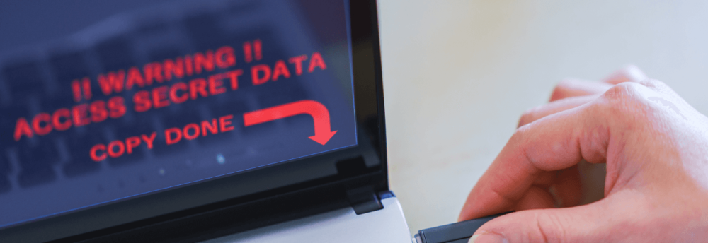 business man steals internal data from computer using USB drive memory